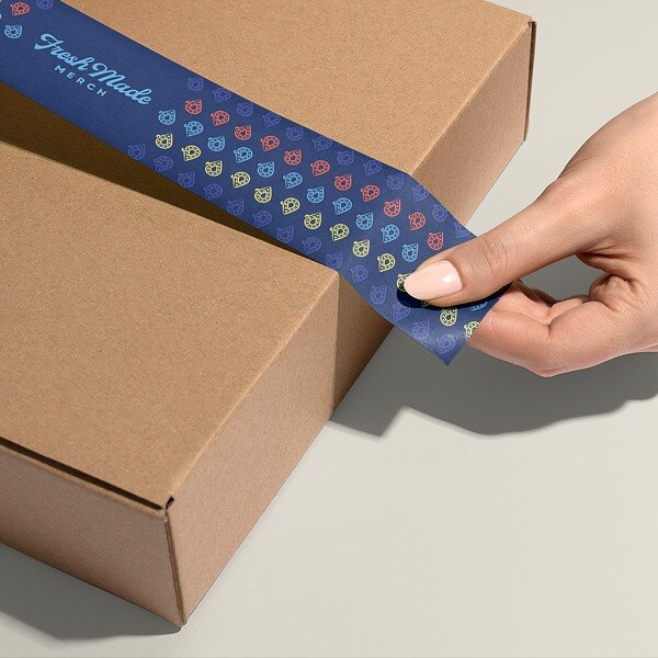 closeup of woman putting tape on a box